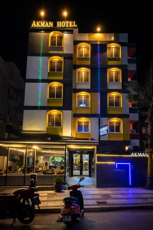 a hotel with motorcycles parked in front of it at Akman City Hotel in Kuşadası