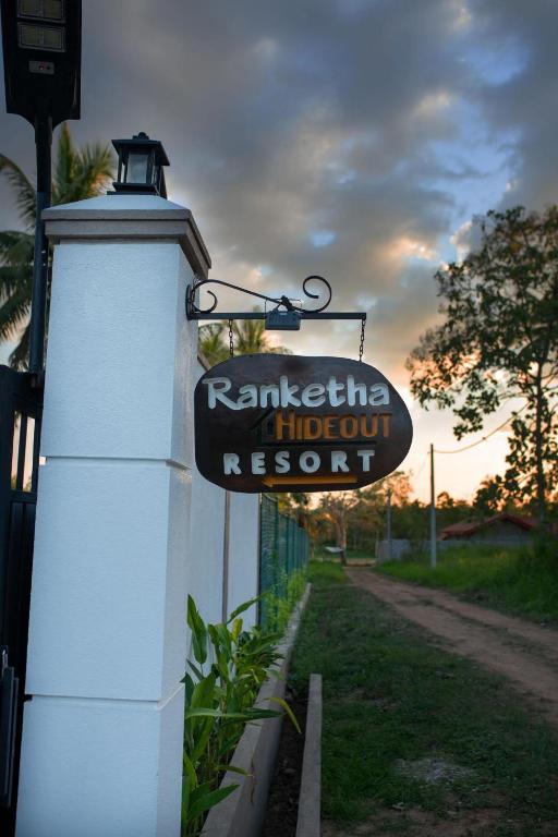 a sign on the side of a building next to a street at Ranketha Hideout Resorts in Kurunegala