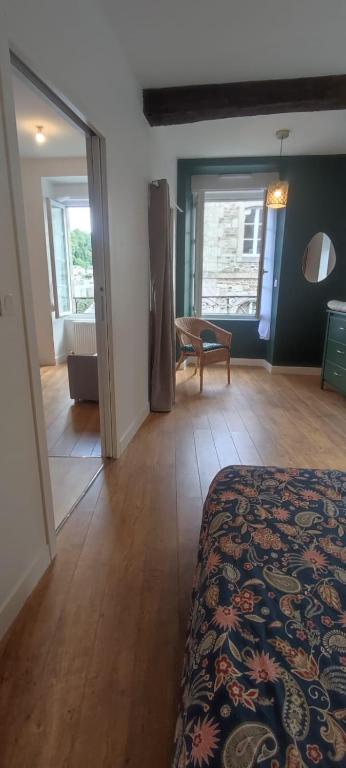 a bedroom with a bed and a living room at Le Cocon - Vue sur le Port de DINAN - Parking privé in Lanvallay