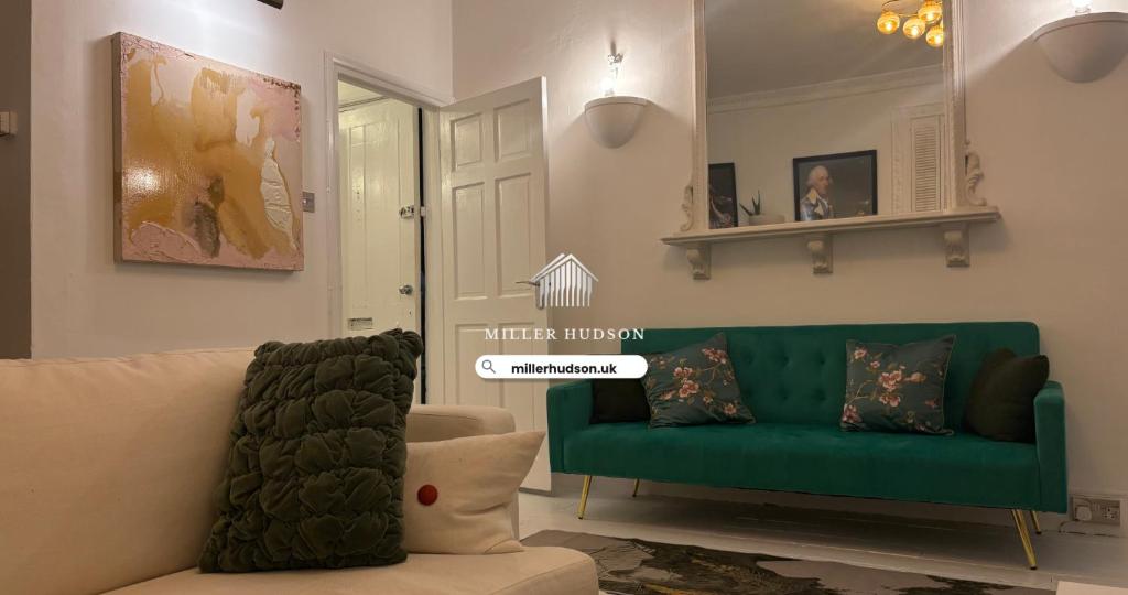 a living room with a green couch and a chair at Pet Friendly 2 Bed Ground Floor Apartment in Addlestone with Free Driveway Parking in Addlestone