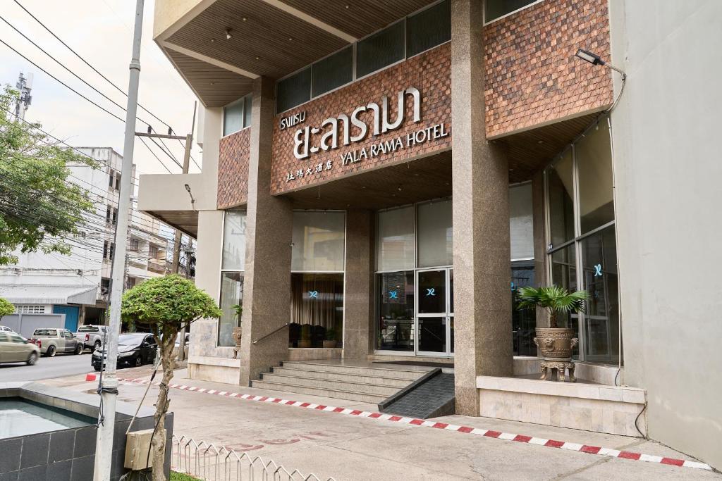 a building with a sign on the front of it at Yala Rama Hotel in Sathani Yala