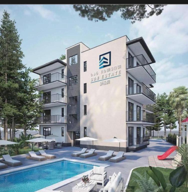an image of a building with a swimming pool at Sun Estate Ureki in Ureki