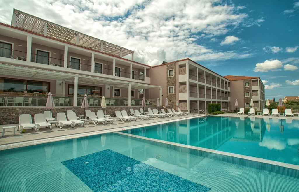 a pool at a hotel with chairs and a building at Arty Grand Hotel in Olympia
