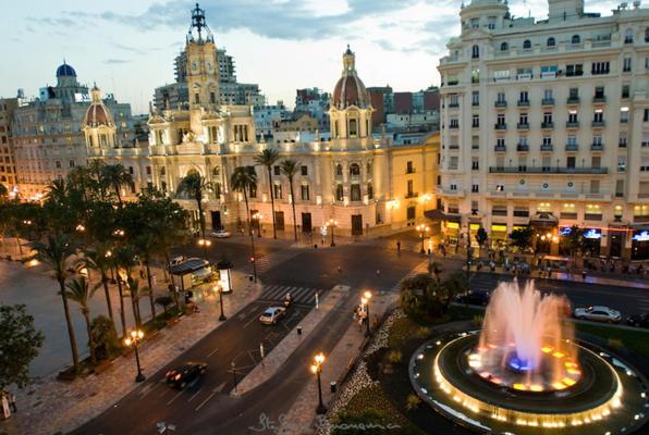 a city street with a fountain in front of a building at MK VALeNCIA in Valencia