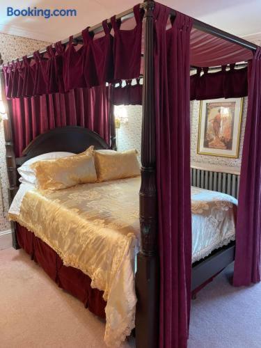 a bedroom with a canopy bed with purple curtains at Hillcrest Bed and Breakfast in Jim Thorpe