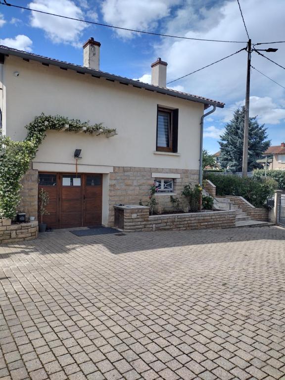 a house with a brick driveway in front of it at Maison à Macon in Mâcon
