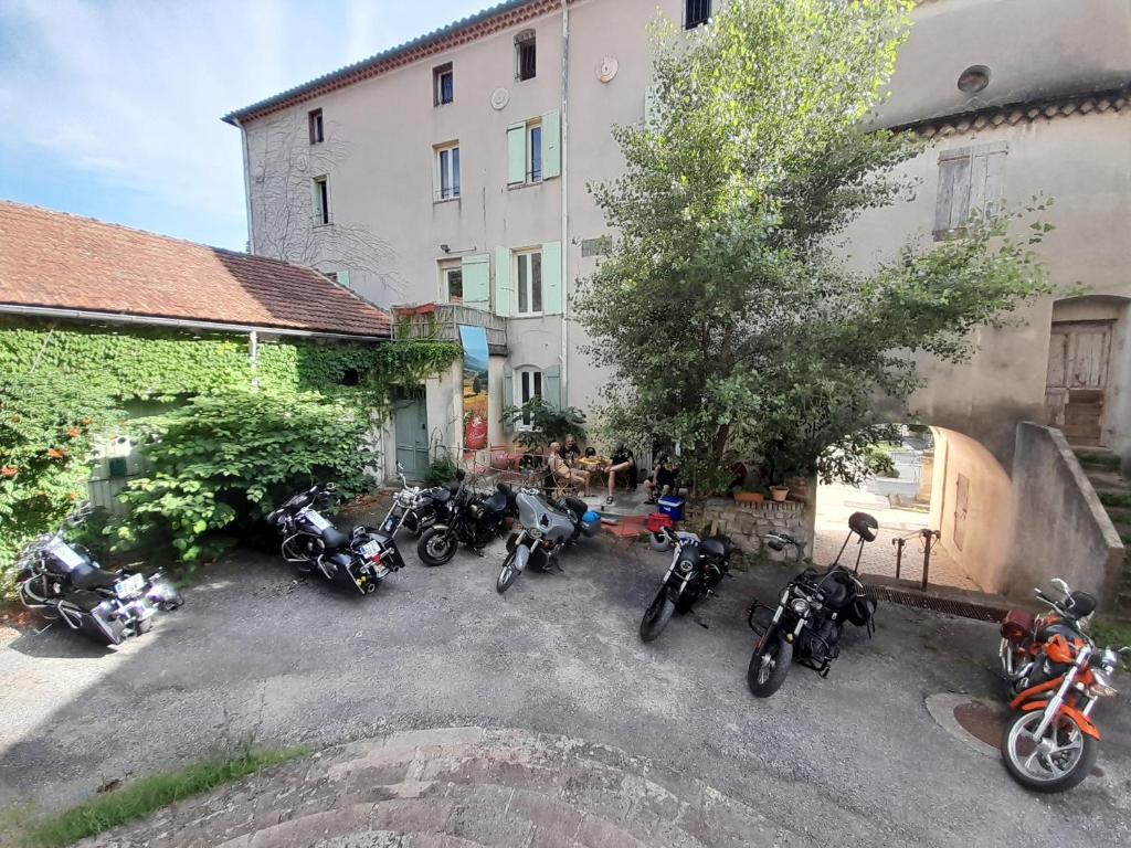 a group of motorcycles parked next to a building at LE PRIEURE in Saint-Florent-sur-Auzonnet