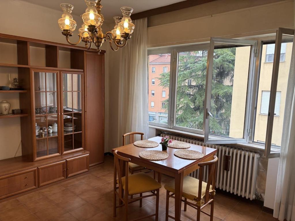 a dining room with a table and a window at Spacious Apartment 20min from Piazza Maggiore in Bologna