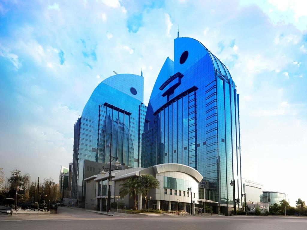 a blue building with eyes on the side of it at Novotel Riyadh Al Anoud in Riyadh