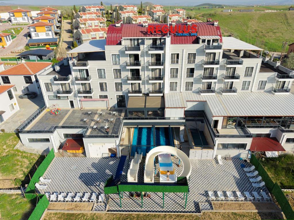 an aerial view of a building with a swimming pool at Afyon Regulus Thermal Apart Hotel & Villas in Gazligol