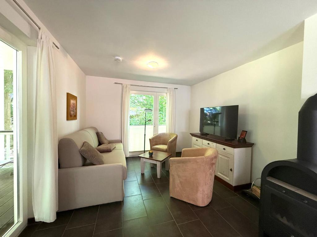 a living room with a couch and a tv at Ferienwohnung W18 0 N in Graal-Müritz