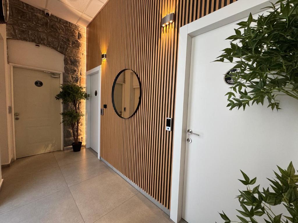 a hallway with a white door and a mirror at City Stay Tiberias - סיטי סטיי טבריה in Tiberias