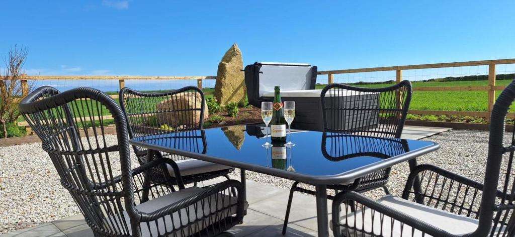 a table and chairs with a bottle of wine on it at 2 Bed in Sennen oc-k35172 in Sennen