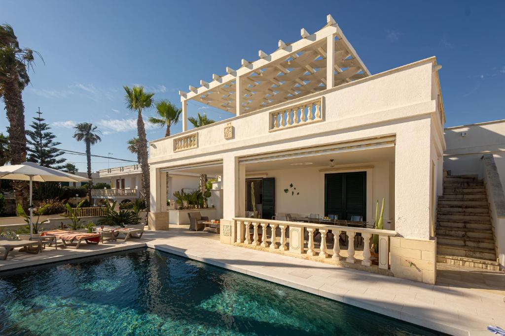 a house with a swimming pool in front of a house at Maison Gioia di Casa Camilla Journey in Capilungo