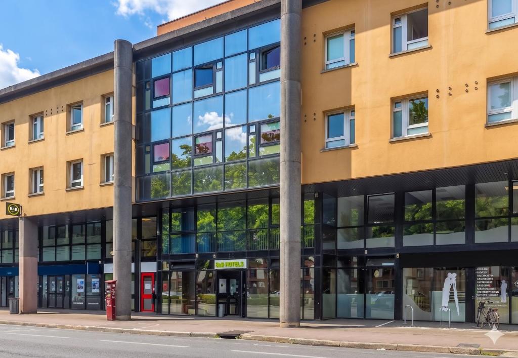 an office building with glass windows on a street at B&B HOTEL Troyes Centre in Troyes