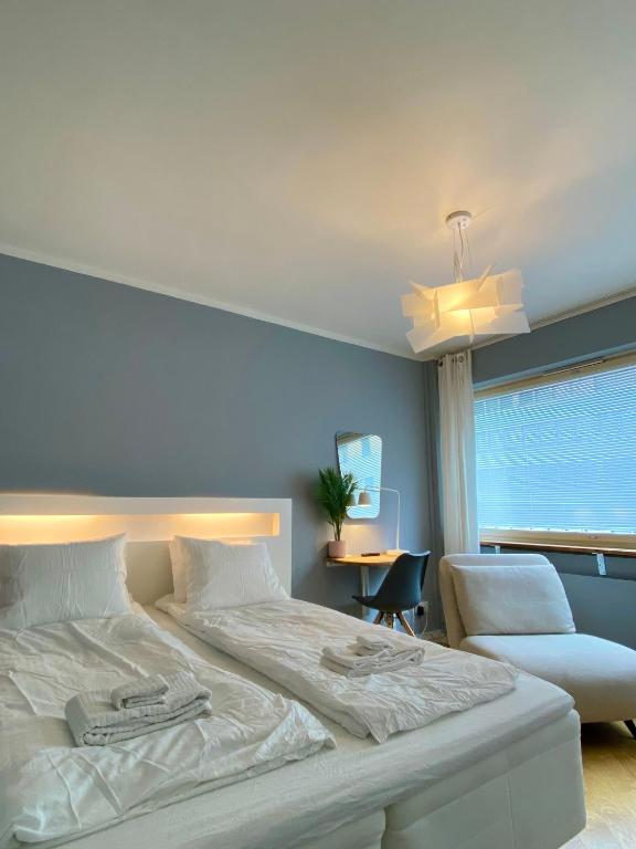 a bedroom with a bed and a chair and a window at Studio Tokoi in Helsinki
