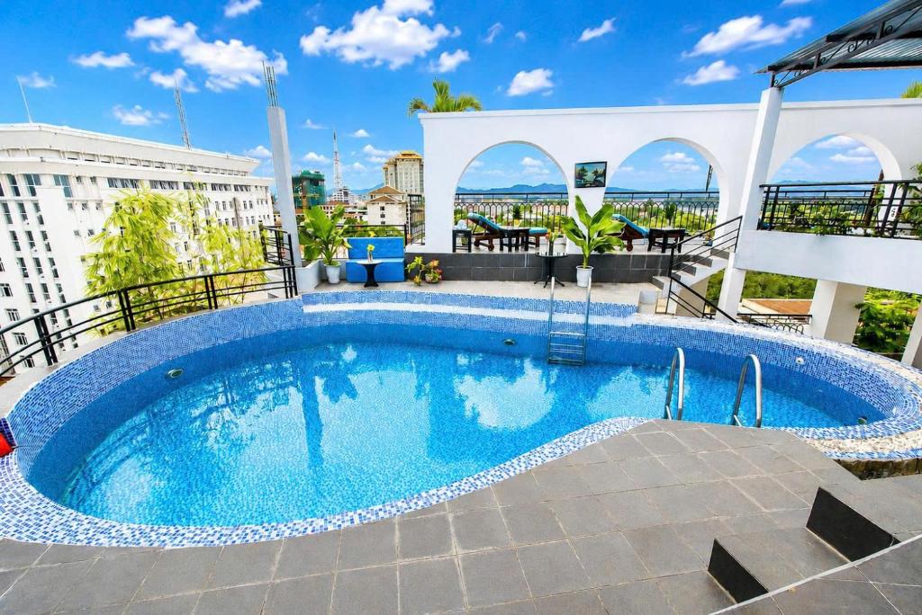 a large swimming pool on top of a building at The Sunriver Boutique Hotel Hue in Hue