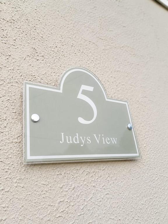 a sign on the side of a building with the physics sign at Judys View in Cashel