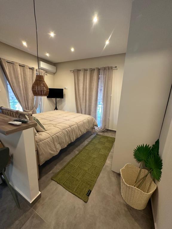 a bedroom with a bed and a table and a plant at Kyma Boutique Suite in Nea Makri