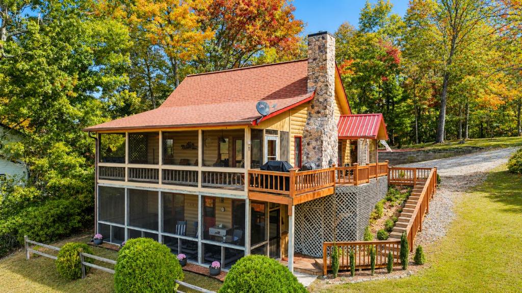 a home with a wrap around porch and a chimney at Peaks & Pines in Morganton