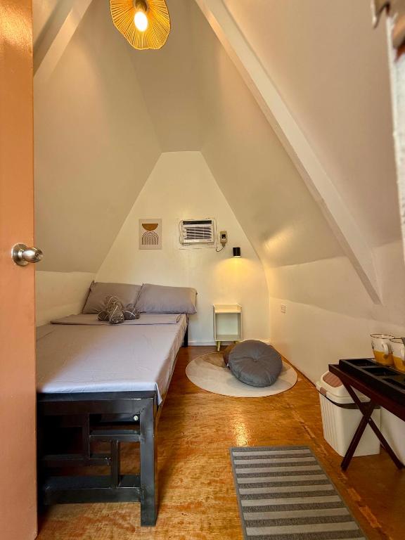 a bedroom with a bed in a attic at Payag ni Peping in Tacloban