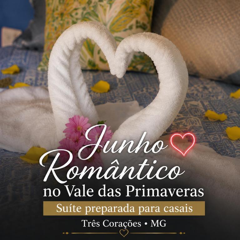 a picture of two white swans forming a heart at Pousada Vale das Primaveras in Três Corações
