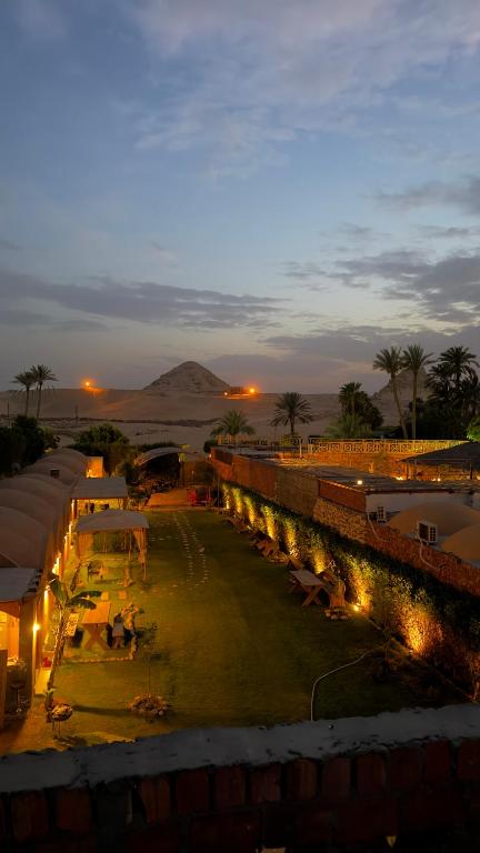 a view of a resort with lights at night at King Sahure Pyramid Inn in Cairo