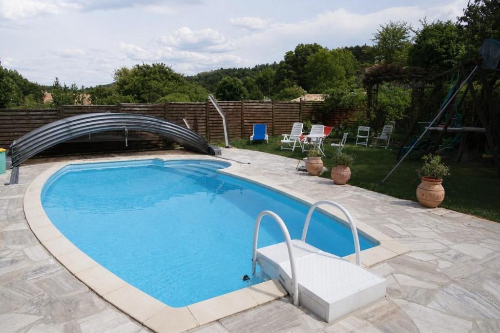 a large swimming pool with a bridge over it at Gîte Clarisse, piscine, animaux, pk in Allemagne-en-Provence
