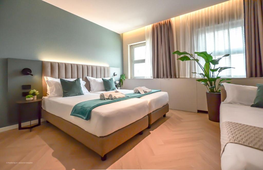 a bedroom with a large bed in a room at CP Hotels - Central in Milan