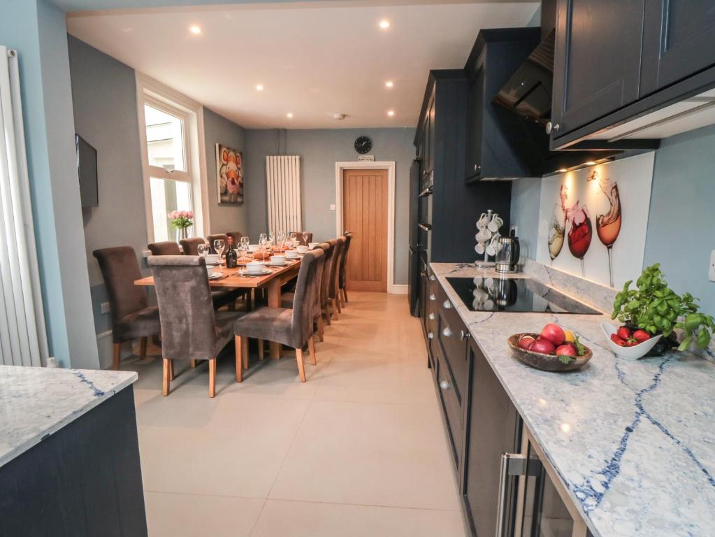 a kitchen and dining room with a table and chairs at Ruby's Retreat in Filey
