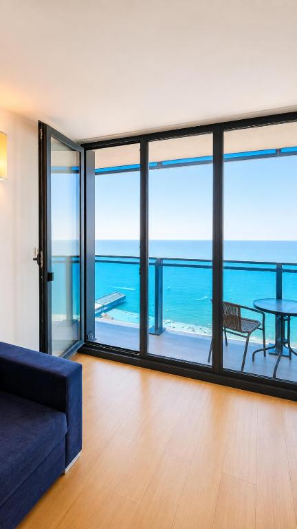 a living room with a view of the ocean at The Infinity Panorama Batumi in Batumi