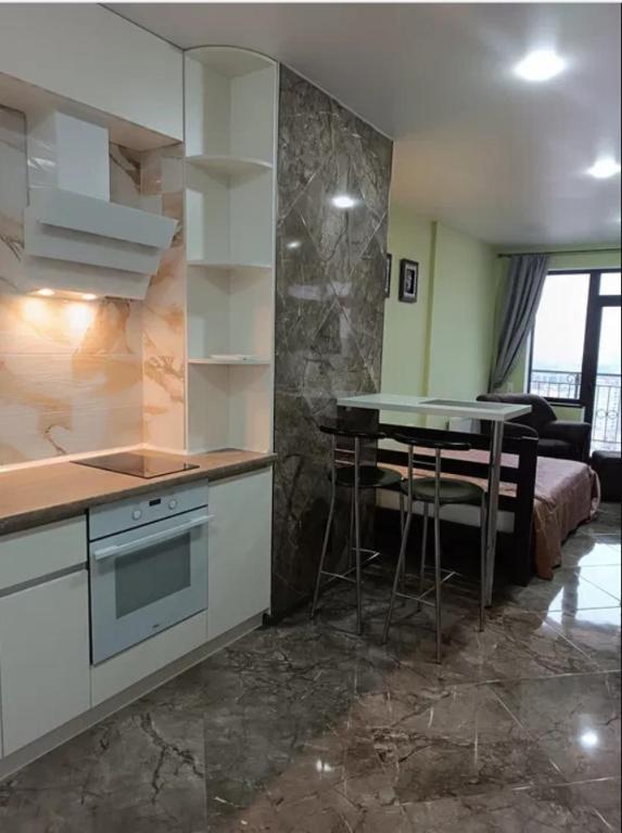 a kitchen with a table and a dining room at ЖК Акрополь, Парк Перемоги, Аркадія in Odesa