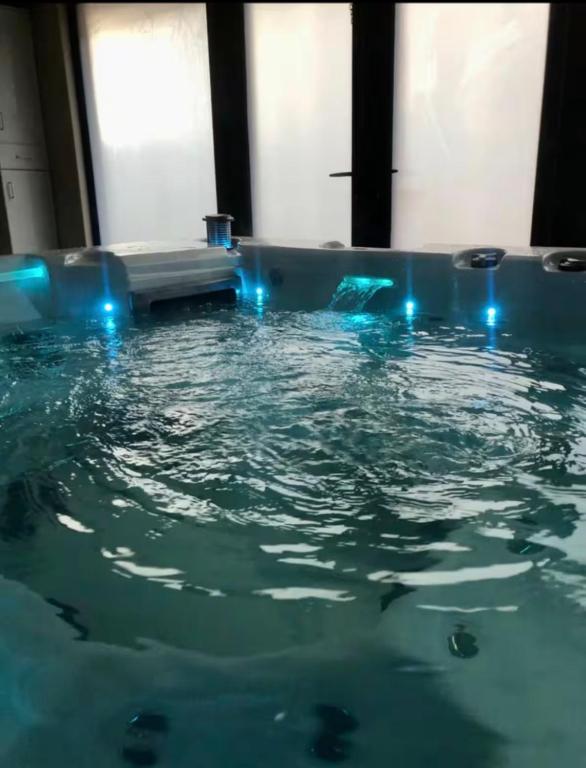 a bath tub filled with water with blue lights at Private Hydro Spa Pool, Dbl Bedrm & Bathrm - Other areas part private shared lived-in home in Bickershaw