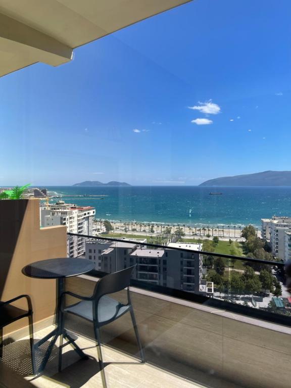 a balcony with a table and chairs and a view of the ocean at Seamare Studio & Apartaments in Vlorë