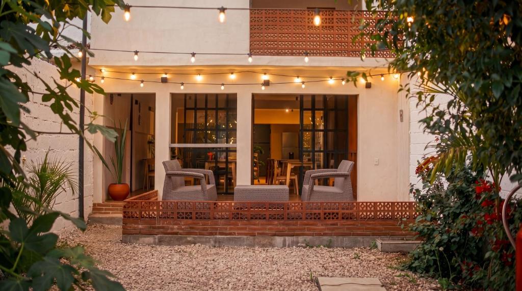 a patio with chairs and lights on a house at Casa Chati Hostal Boutique in San Cristóbal de Las Casas