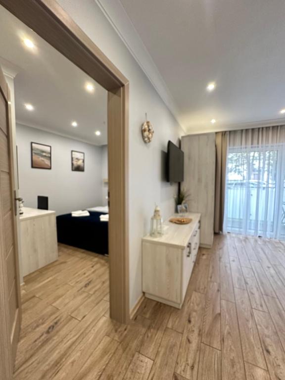 a large room with a bedroom and a living room at Maximus in Ustka