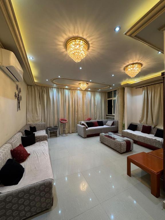 a living room with two couches and a table at Ras elbar Palace in Ras El Bar