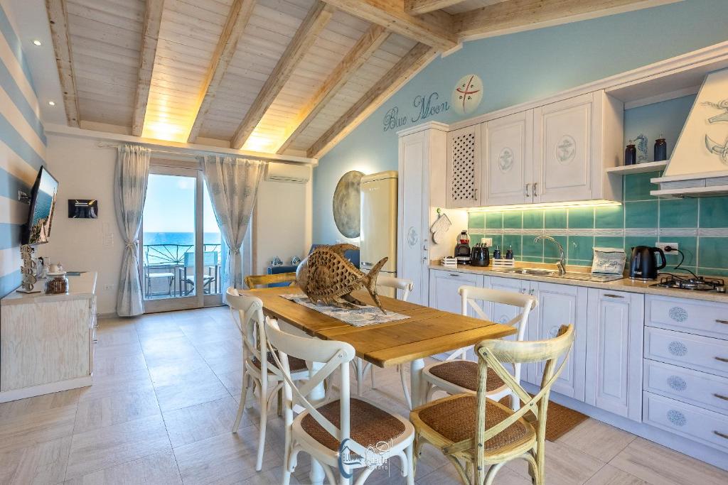 a kitchen with a wooden table and chairs at Blue Moon in Castelsardo