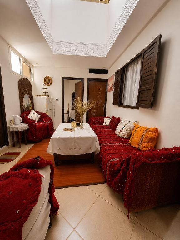 a large living room with two beds and a table at Dar Amine in Rabat