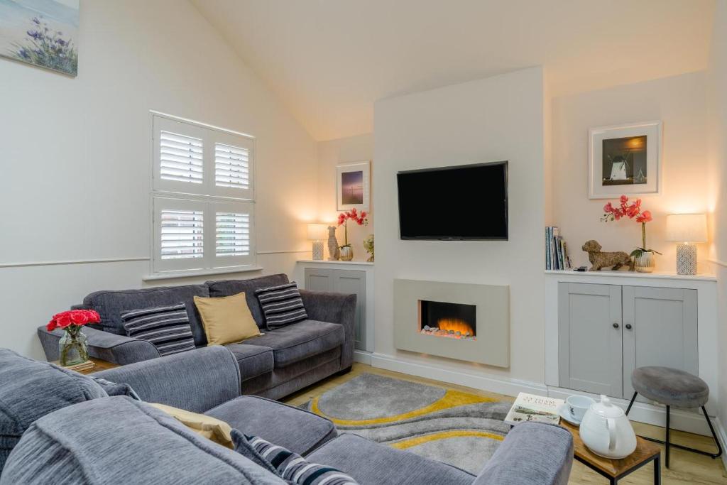 a living room with a couch and a fireplace at 1 Bed in Lytham St. Annes oc-86044 in Saint Annes on the Sea
