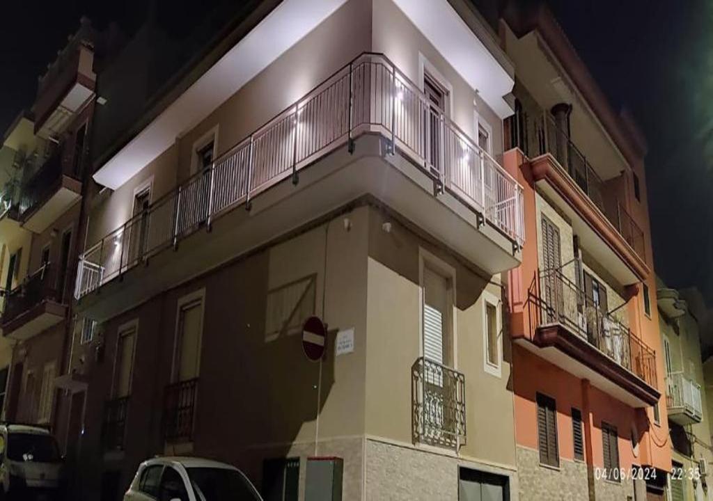a building with a balcony on the side of it at L'Ulivo in Massafra