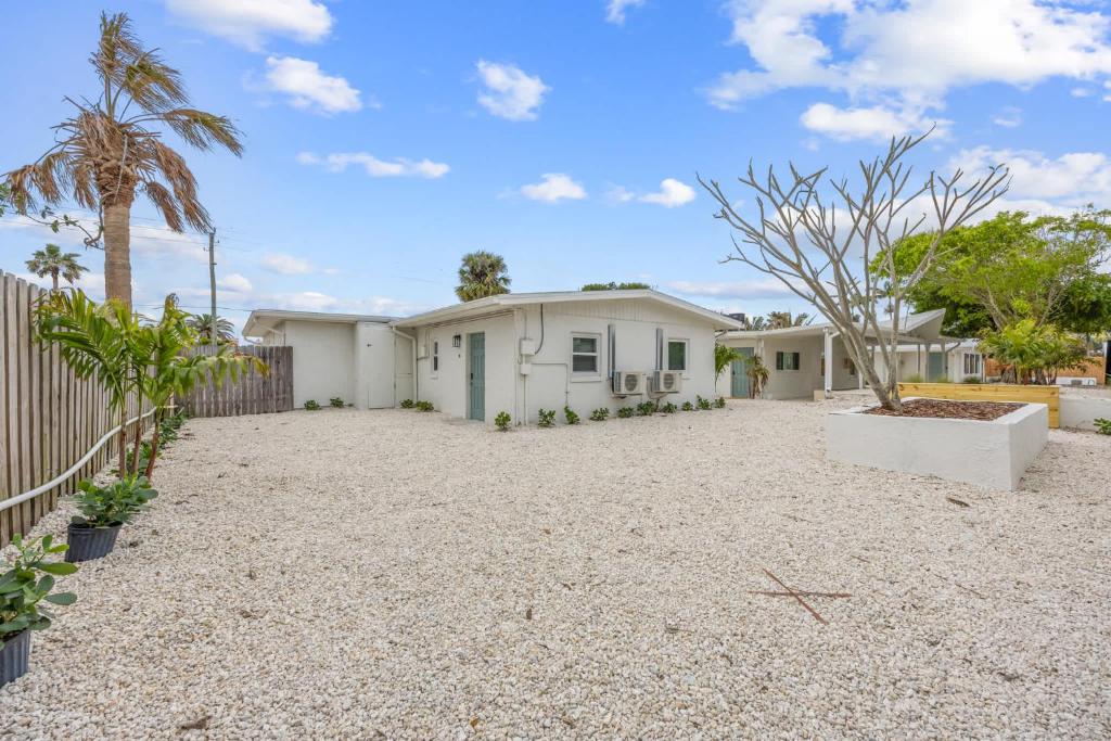 a house with a gravel driveway in front of it at Dune Drift in Cocoa Beach