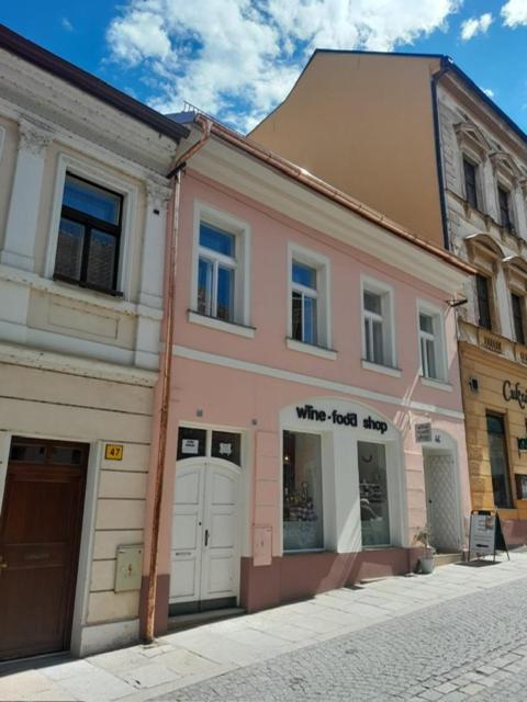a pink building on the side of a street at Apartmán Růženka Písek in Písek