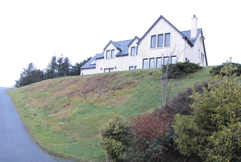 a white house on top of a hill at Seafar Bed & Breakfast in Portree