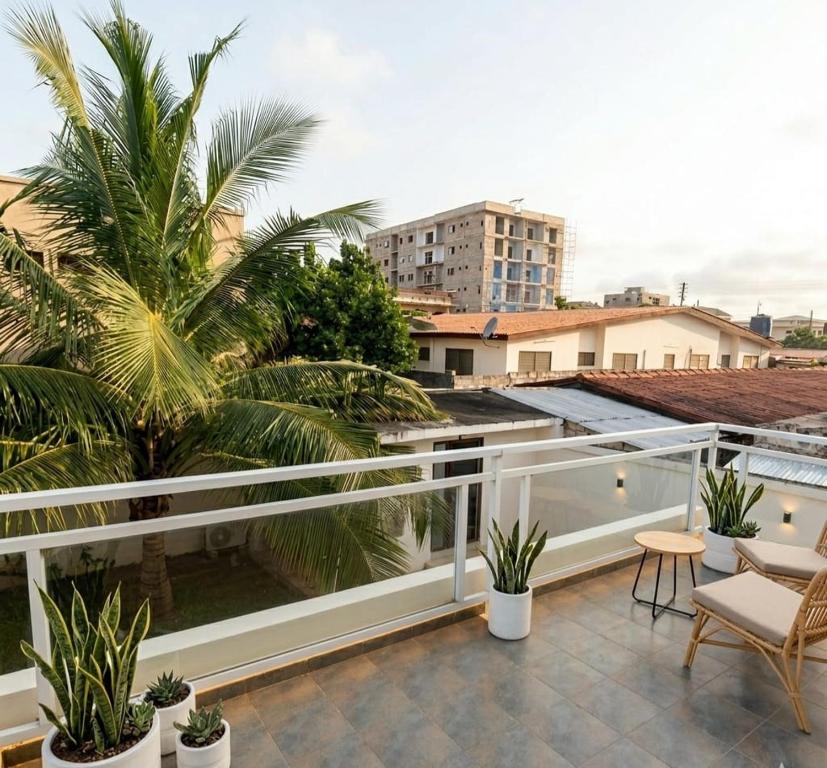 a view from the balcony of a apartment with palm trees at M Residence in Accra