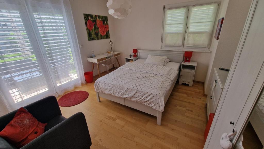 a small bedroom with a bed and a couch at BnB "Les Coquelicots" in Mies
