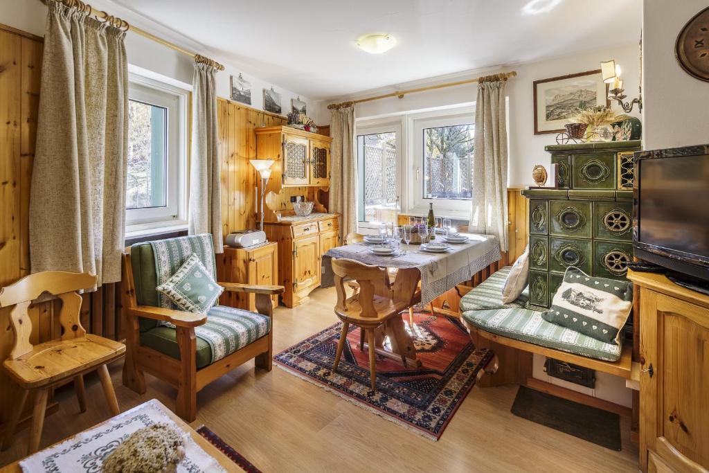 a living room with a table and chairs at CiasaToa in Cortina dʼAmpezzo