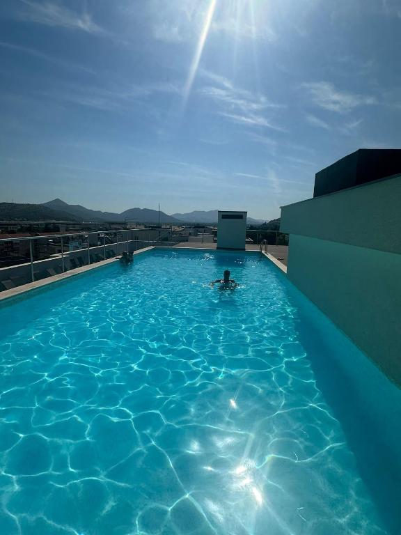 a person in a swimming pool on top of a building at Charlie in Trebinje