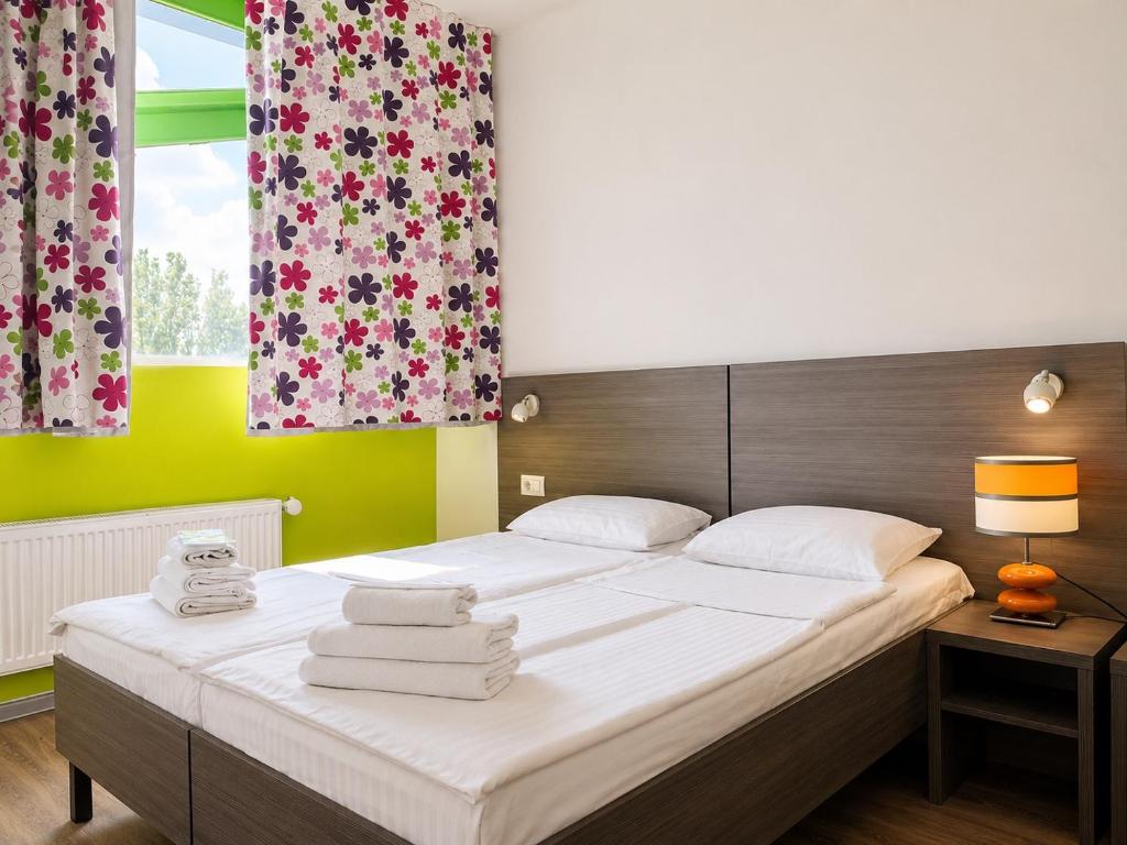 a bedroom with a bed with towels on it at Mare nero in Odesa
