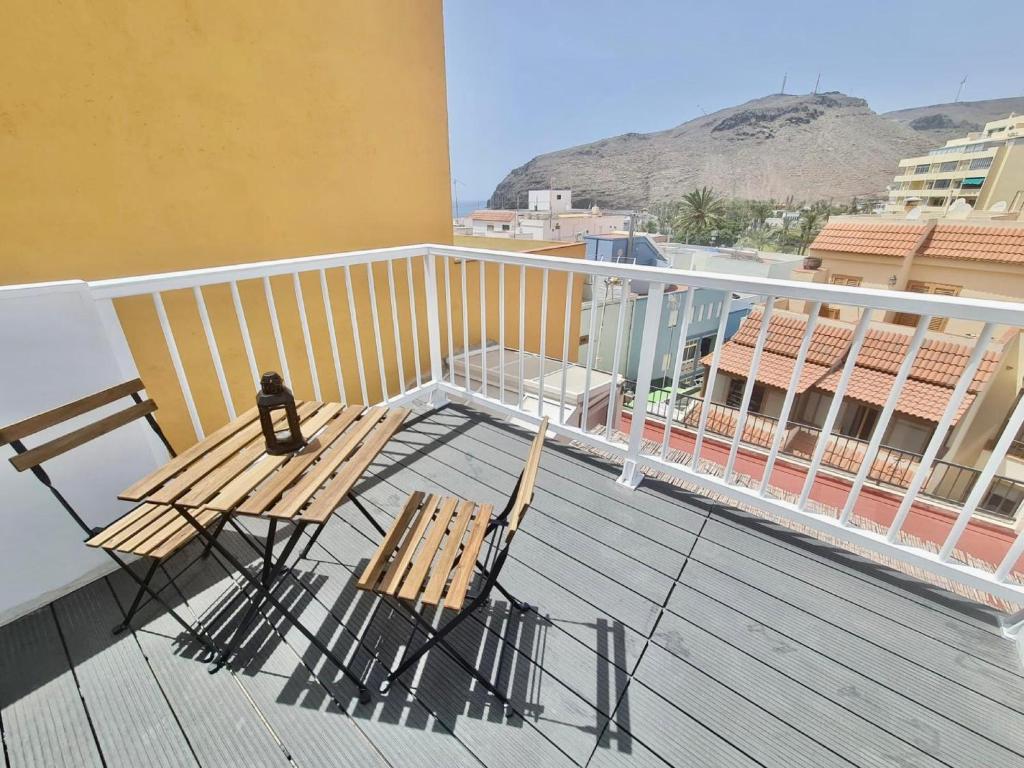 a balcony with two chairs and a bench on a deck at Apartamento La Pista Sur in San Sebastián de la Gomera